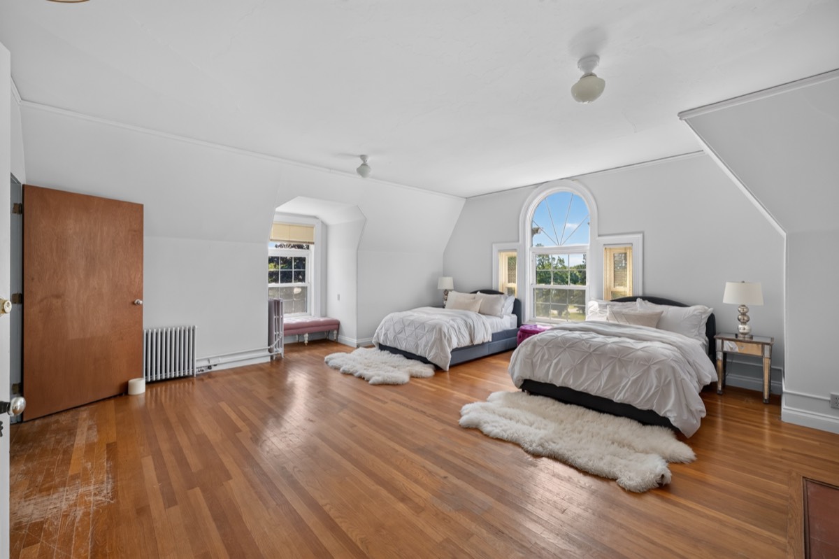 A bedroom with an arched window